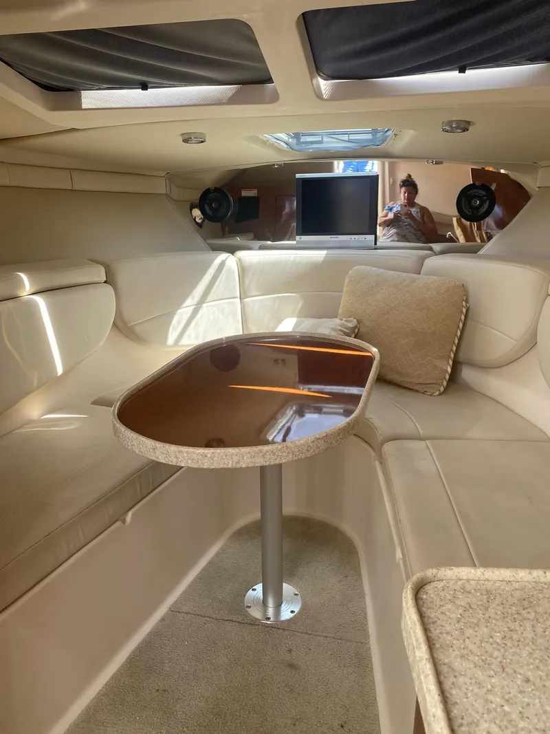 Slide: The Image of 2006 Regal 2860 Window Express cabin interior with seating and table. - 16