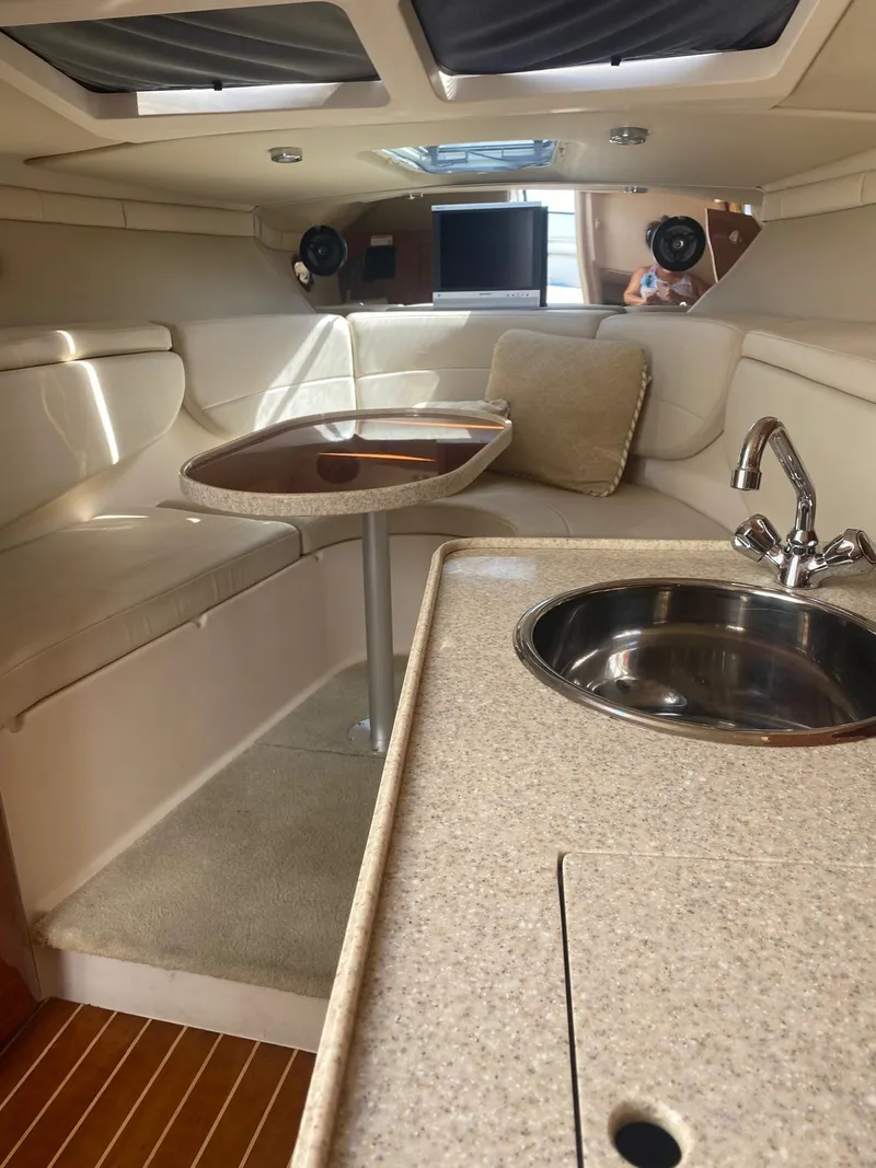 Slide: The Image of 2006 Regal 2860 Window Express cabin interior with kitchenette and seating area. - 17