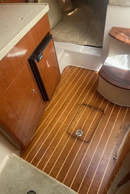 Slide: The Image of 2006 Regal 2860 Window Express cabin interior with wood flooring and compact kitchenette. - 18