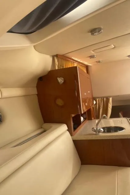 Slide: The Image of Interior of 2006 Regal 2860 Window Express boat with kitchenette and seating area. - 19