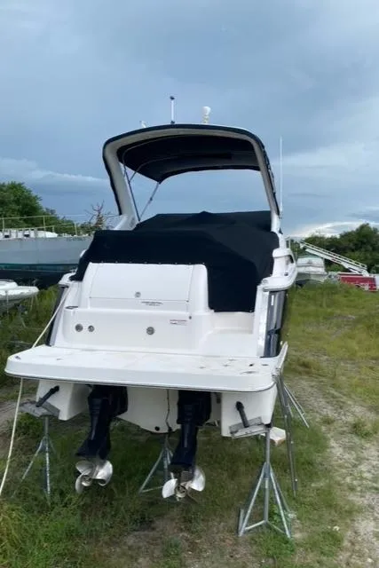 Slide: The Image of 2006 Regal 2860 Window Express boat on stands, covered, outdoors. - 2