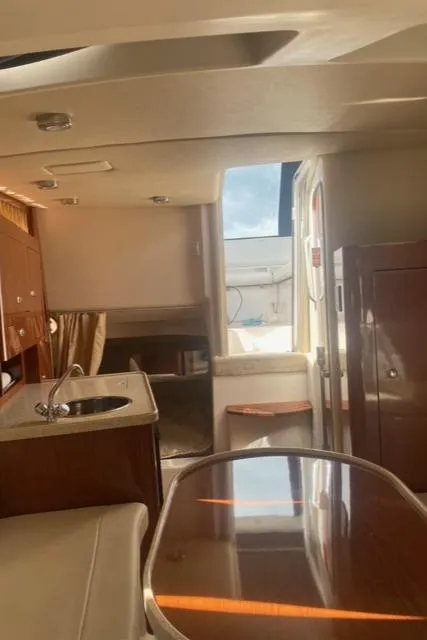 Slide: The Image of Interior of 2006 Regal 2860 Window Express boat with kitchenette and seating area. - 20