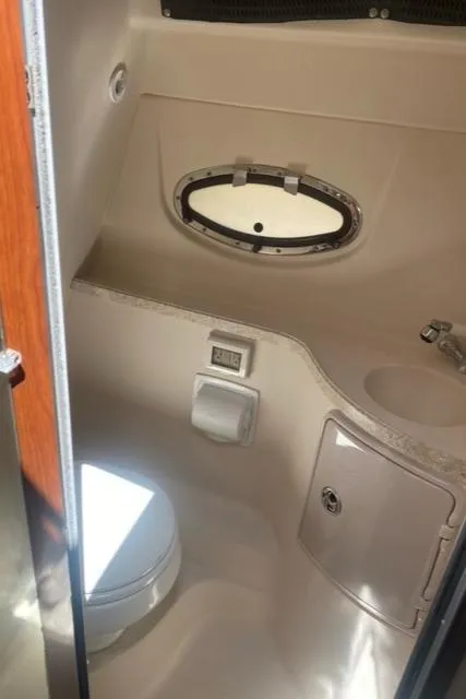 Slide: The Image of 2006 Regal 2860 Window Express boat bathroom with toilet and sink. - 21