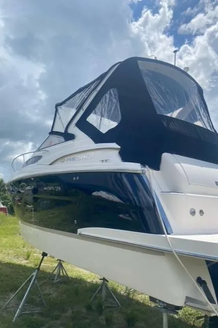 Slide: The Image of 2006 Regal 2860 Window Express boat on stands under cloudy sky. - 4
