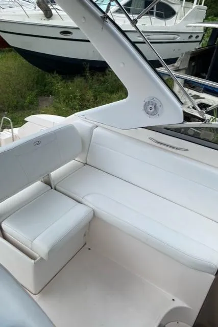 Slide: The Image of 2006 Regal 2860 Window Express boat interior with white seating and sleek design. - 9