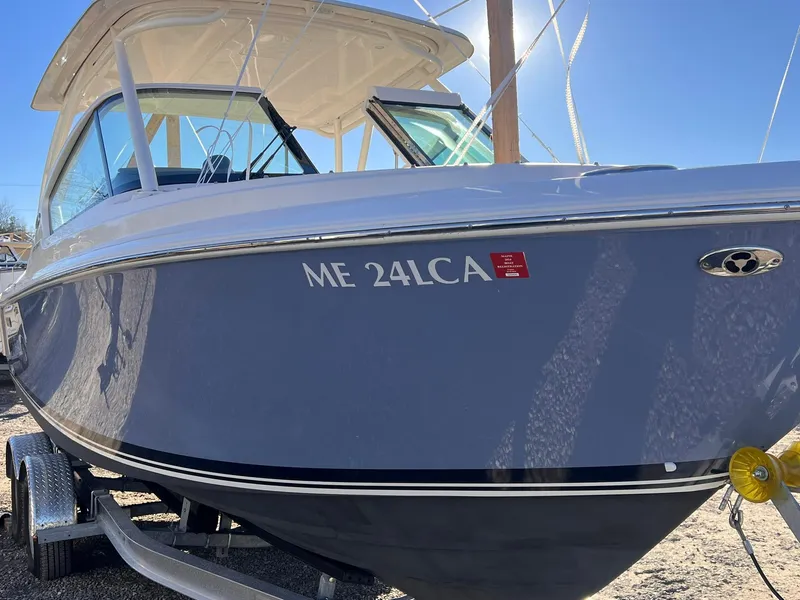 Slide: The Image of 2022 Pursuit DC 266 Dual Console boat on trailer, side view. - 20