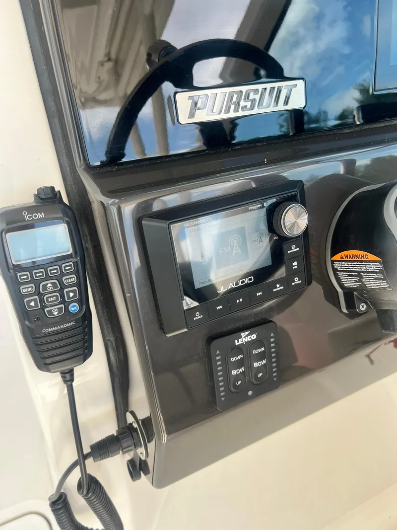 Slide: The Image of 2022 Pursuit DC 266 Dual Console dashboard with radio and controls. - 31