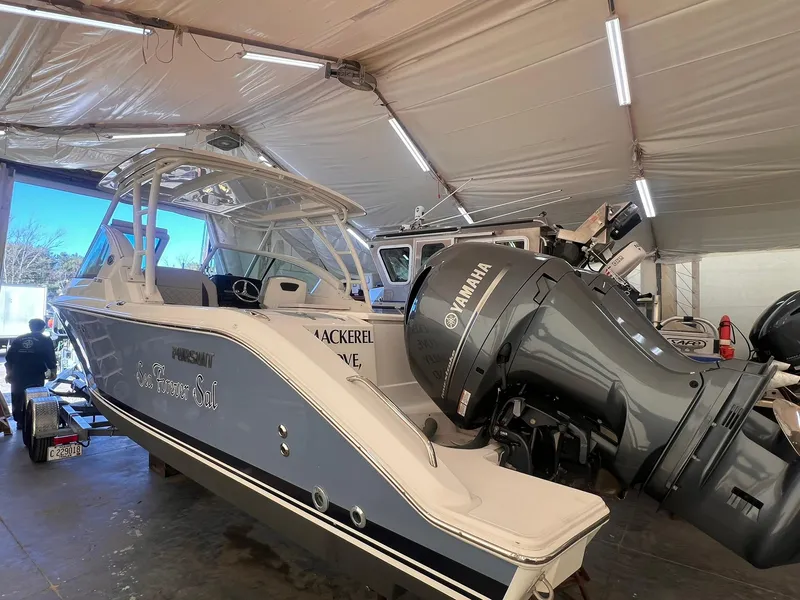 Slide: The Image of 2022 Pursuit DC 266 Dual Console boat with Yamaha engine in storage. - 36