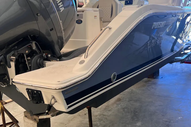 Slide: The Image of 2022 Pursuit DC 266 Dual Console boat with Yamaha outboard engine in a garage. - 38