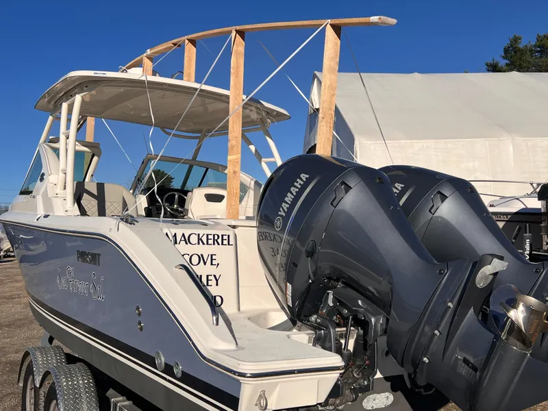 Slide: The Image of 2022 Pursuit DC 266 Dual Console boat with Yamaha engines, docked outdoors. - 4