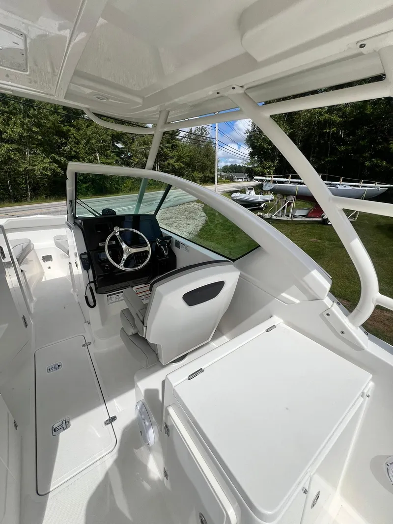 Slide: The Image of 2022 Pursuit DC 266 Dual Console boat interior with steering wheel and seating. - 41