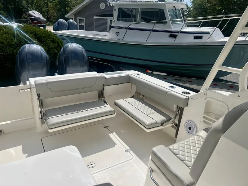 Slide: The Image of 2022 Pursuit DC 266 Dual Console boat interior with seating and twin engines. - 5