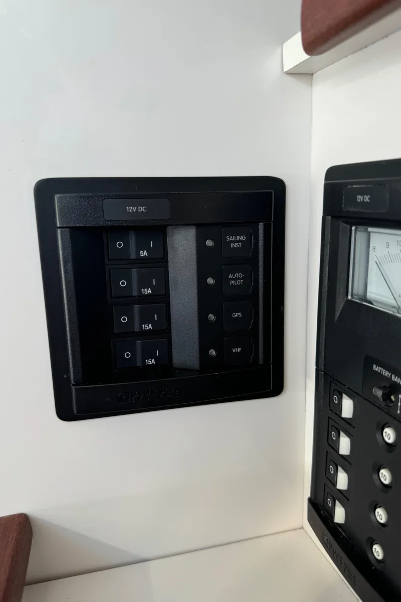 Slide: The Image of Control panel on 2022 J Boats J/9 sailboat, featuring switches and gauges. - 17