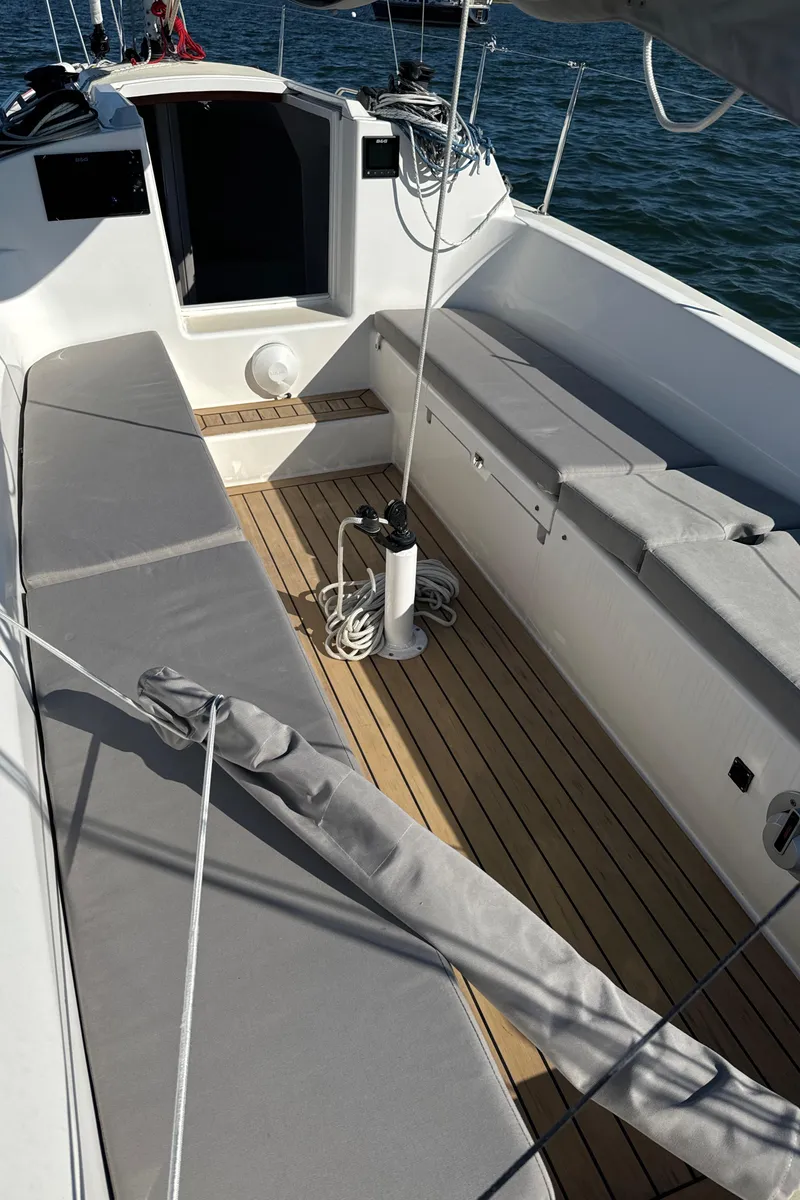 Slide: The Image of 2022 J Boats J/9 sailboat cockpit with cushioned seating and teak flooring. - 2