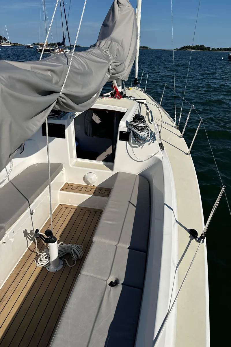 Slide: The Image of 2022 J Boats J/9 sailboat with covered sails on calm water. - 3