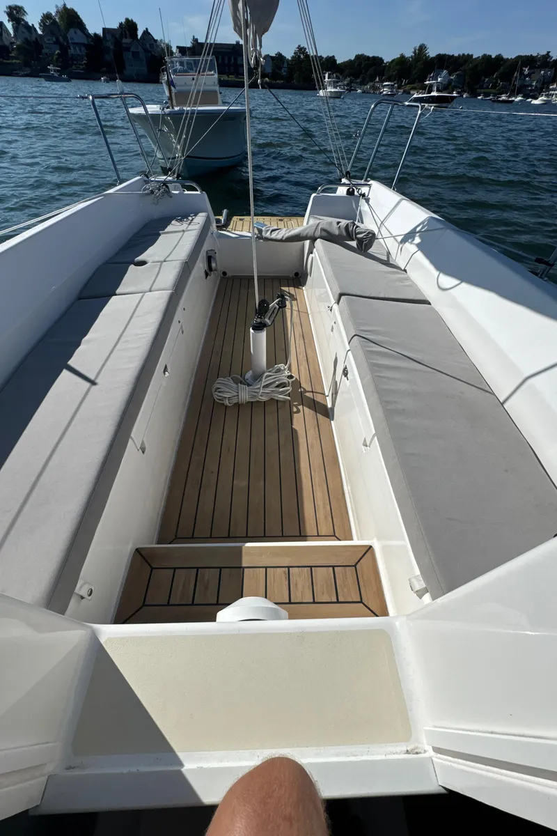 Slide: The Image of 2022 J Boats J/9 sailboat interior with cushioned seating and wooden deck. - 6