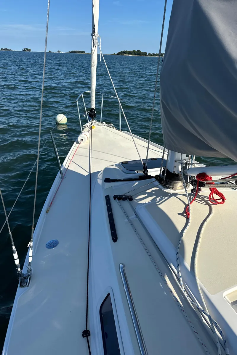 Slide: The Image of 2022 J Boats J/9 sailboat on calm water, showcasing deck and rigging. - 8