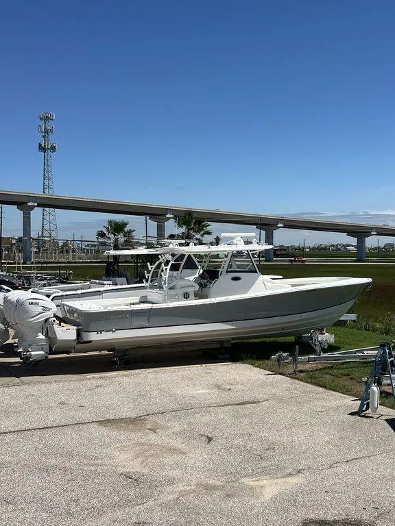 Slide: The Image of 2021 Regulator 41 boat on trailer under clear blue sky. - 1