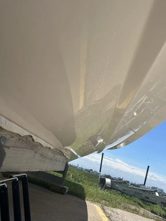 Slide: The Image of 2021 Regulator 41 boat hull, parked outdoors on a sunny day. - 10