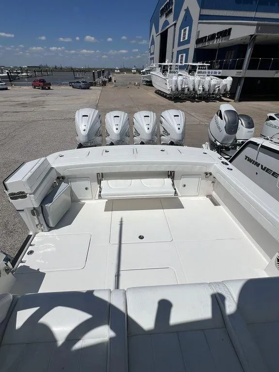 Slide: The Image of 2021 Regulator 41 boat with multiple outboard engines at a marina. - 14