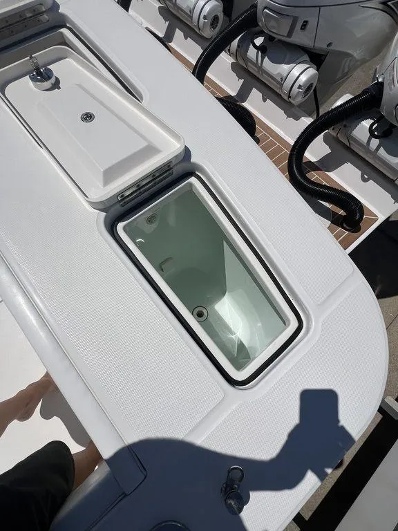 Slide: The Image of 2021 Regulator 41 boat deck with storage compartments and engines. - 16