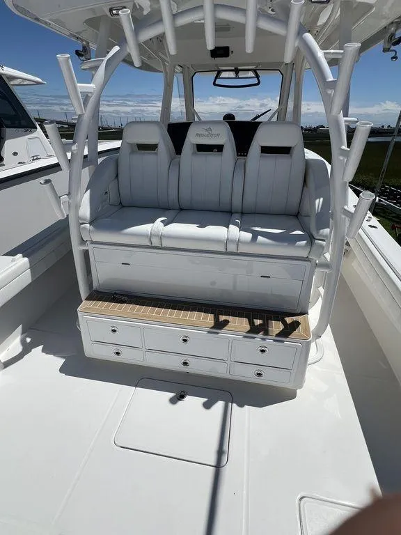 Slide: The Image of 2021 Regulator 41 boat interior with white seating and storage drawers. - 18