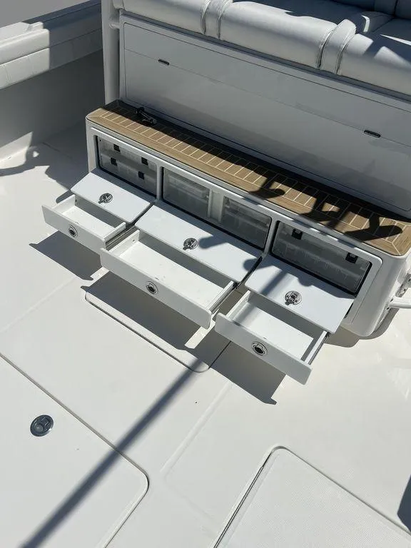 Slide: The Image of 2021 Regulator 41 boat storage drawers open on deck. - 19