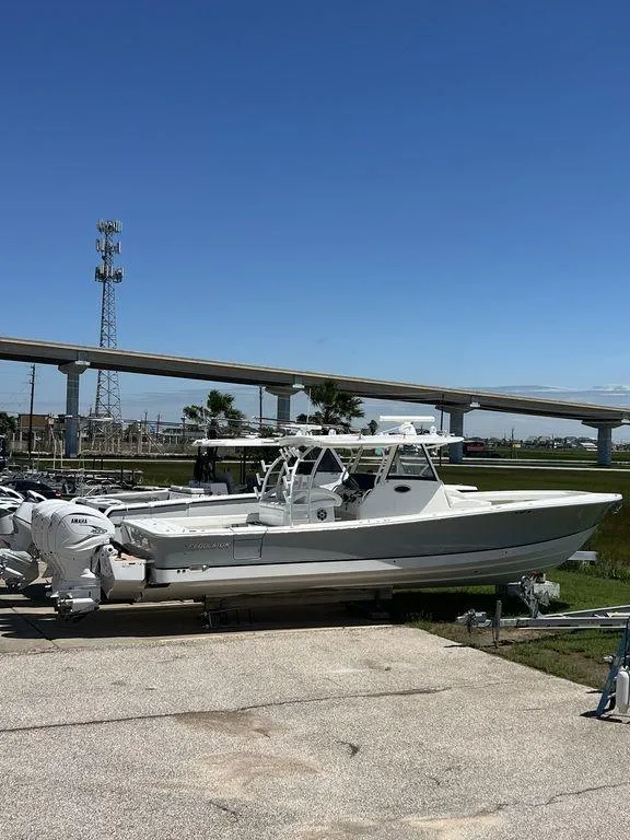Slide: The Image of 2021 Regulator 41 boat docked under clear blue sky. - 2