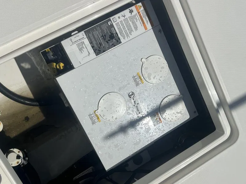Slide: The Image of 2021 Regulator 41 boat compartment with electrical components and wiring. - 24