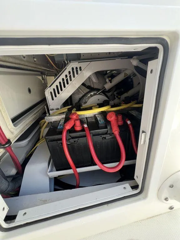 Slide: The Image of 2021 Regulator 41 boat battery compartment with red cables and secure housing. - 31