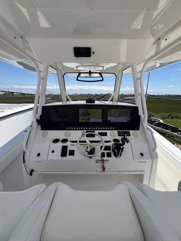 Slide: The Image of 2021 Regulator 41 boat cockpit with advanced navigation system and controls. - 32
