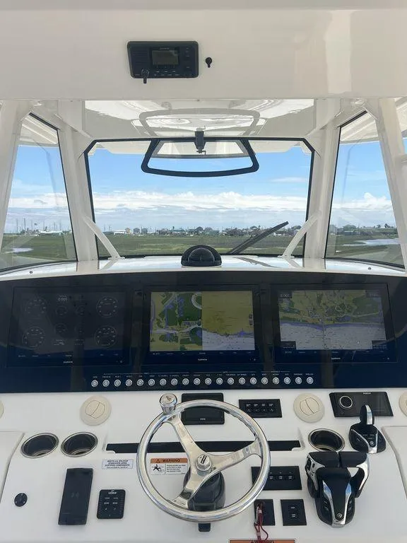 Slide: The Image of 2021 Regulator 41 boat cockpit with advanced navigation system and steering wheel. - 33