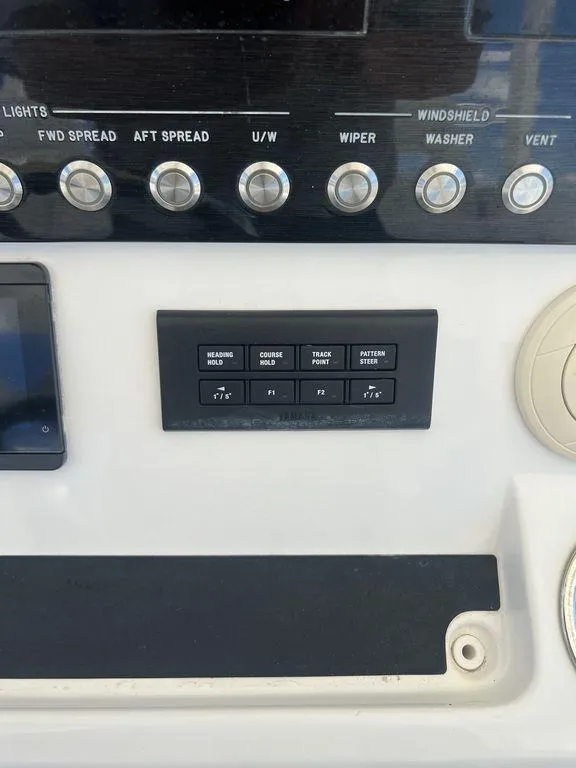 Slide: The Image of Control panel of a 2021 Regulator 41 boat with various switches and buttons. - 40