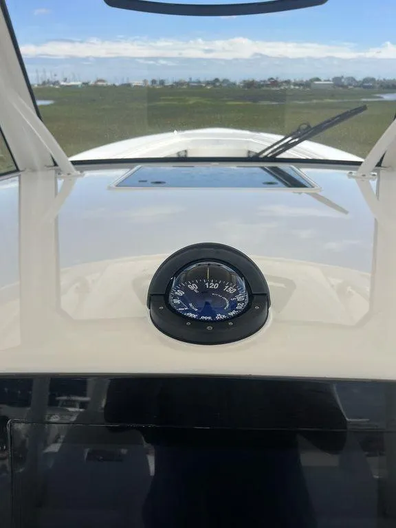 Slide: The Image of 2021 Regulator 41 boat dashboard with compass, clear sky in background. - 42