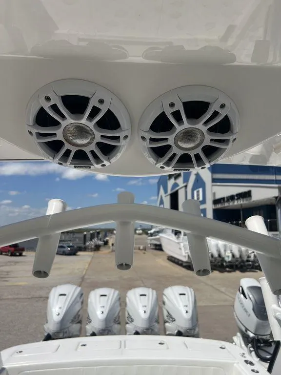 Slide: The Image of 2021 Regulator 41 boat with speakers and multiple outboard engines at a marina. - 44