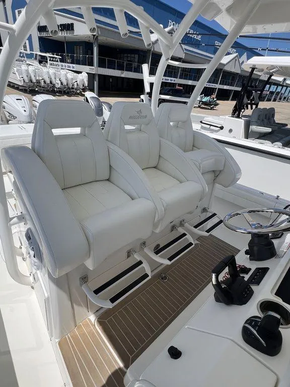 Slide: The Image of 2021 Regulator 41 boat with white captain's chairs and modern helm controls. - 47