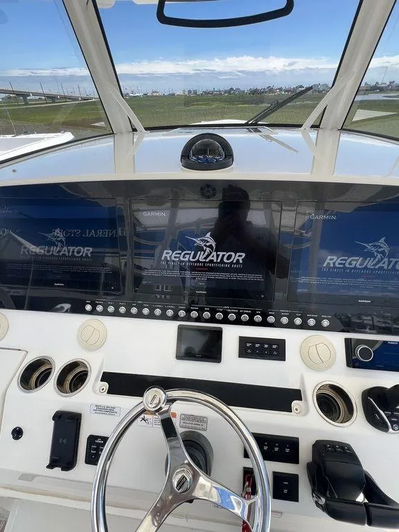 Slide: The Image of 2021 Regulator 41 boat dashboard with advanced navigation displays and controls. - 49