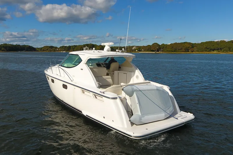 Slide: The Image of 2008 Tiara Yachts 3900 Sovran cruising on a calm lake under a clear sky. - 2