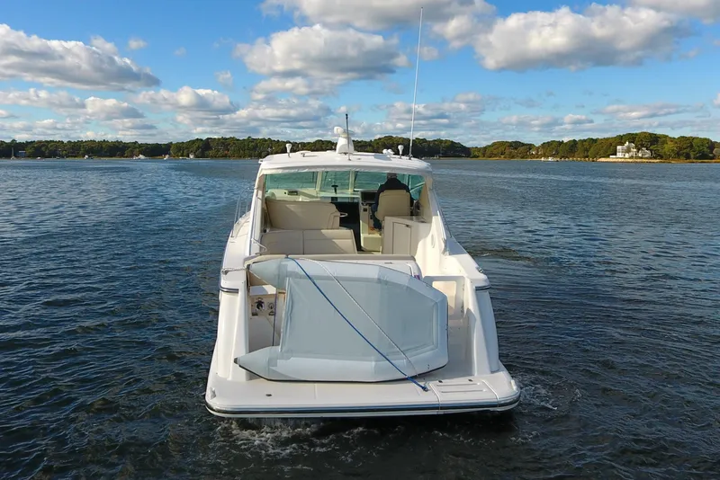 Slide: The Image of 2008 Tiara Yachts 3900 Sovran on calm water under a blue sky. - 3