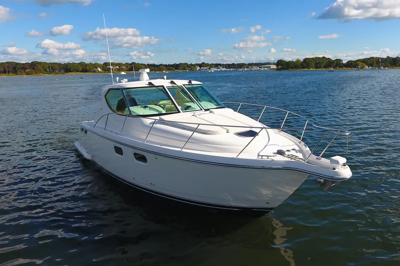 Slide: The Image of 2008 Tiara Yachts 3900 Sovran cruising on a serene lake under a blue sky. - 8