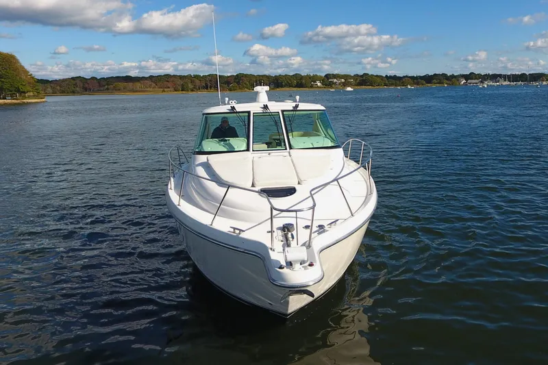 Slide: The Image of 2008 Tiara Yachts 3900 Sovran cruising on a serene lake under a blue sky. - 9