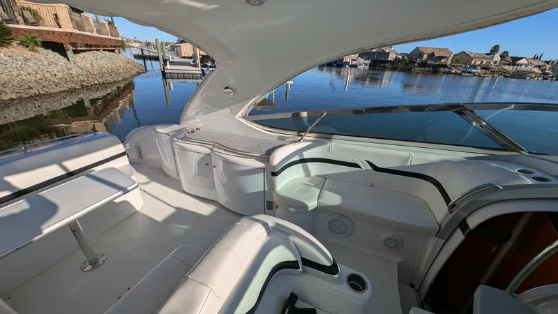Slide: The Image of 2007 Formula 400ss yacht interior with white seating, docked in a serene marina. - 10