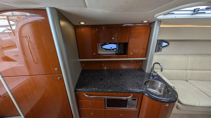 Slide: The Image of Luxurious 2007 Formula 400ss yacht interior with sleek kitchenette and modern amenities. - 22
