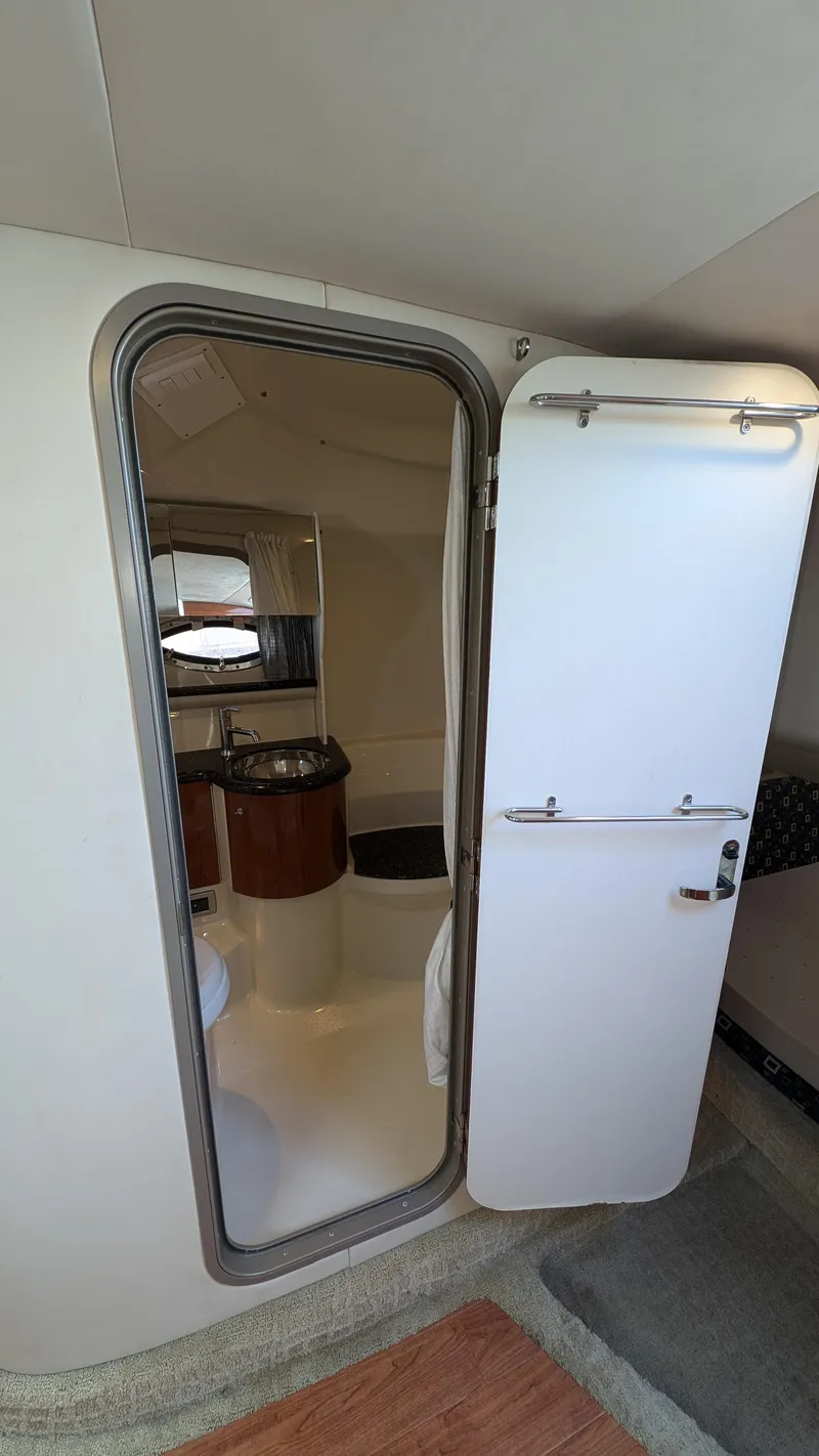 Slide: The Image of Interior of a 2007 Formula 400ss boat showing cabin door and bathroom area. - 23