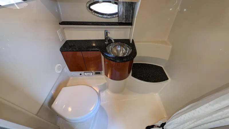 Slide: The Image of 2007 Formula 400ss yacht bathroom with sink, toilet, and porthole window. - 26