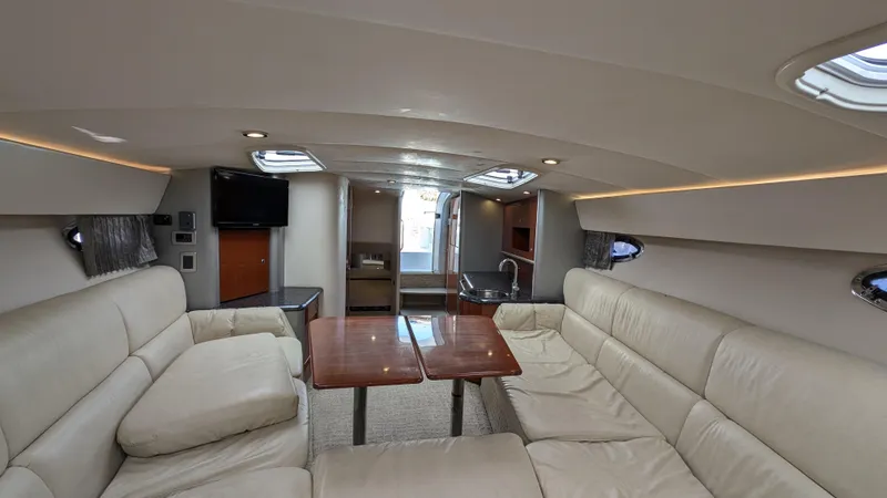 Slide: The Image of Luxurious interior of a 2007 Formula 400ss yacht with beige leather seating and wooden tables. - 27