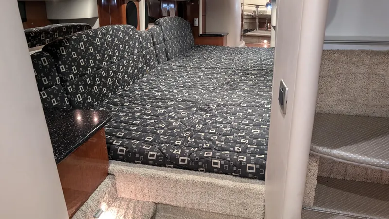 Slide: The Image of Interior of 2007 Formula 400ss boat with patterned bedding and carpeted stairs. - 29