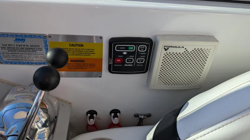 Slide: The Image of Control panel of a 2007 Formula 400ss boat with warning labels and speaker. - 37