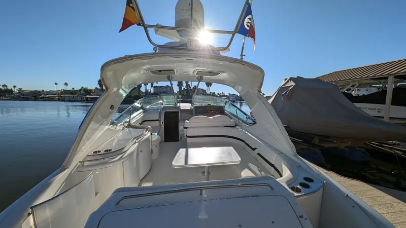 Slide: The Image of 2007 Formula 400ss boat with flags, docked under clear blue sky. - 4