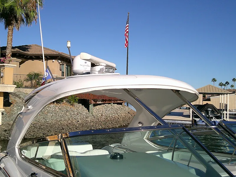 Slide: The Image of 2007 Formula 400ss boat docked near waterfront home, clear sky, American flag. - 5